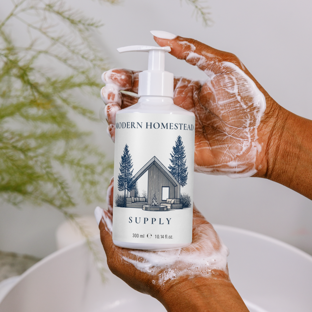 Hand holding a 'Modern Homestead Supply' bottle with soap suds, blurred greenery in the background