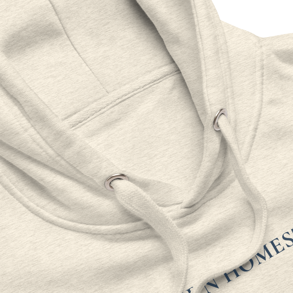 Close-up of a light gray hoodie with a brand logo on a white background