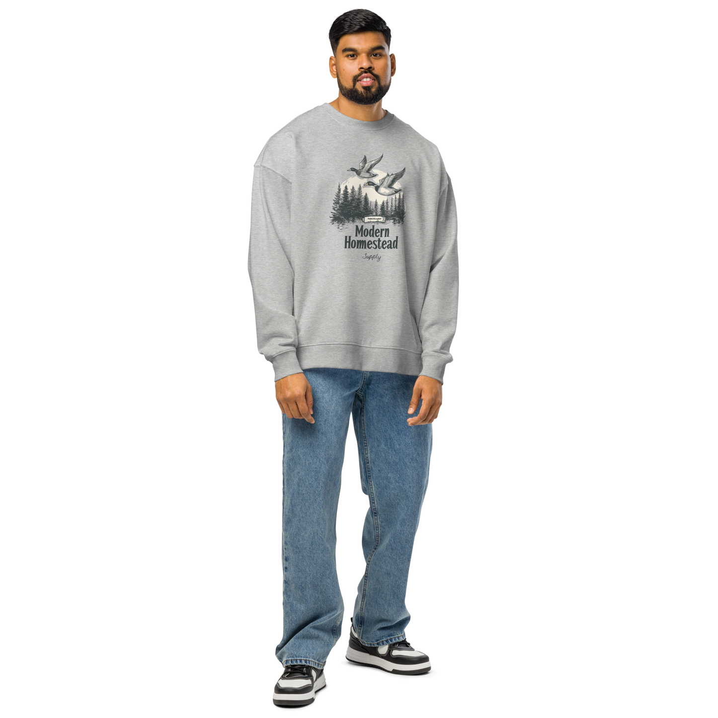 Man wearing a gray sweatshirt with a graphic design on a white background
